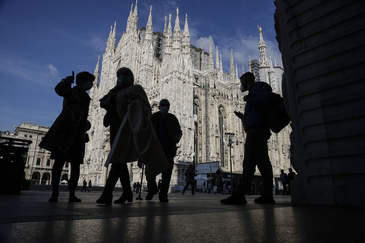People wear masks to curb the spread of COVID-19 as they walk next to the Duomo gothic cathedral, in Milan, Italy, Friday, Oct. 16, 2020. Italian health officials have declared the country in an "acute phase" after the country set records for new daily cases higher than even during the March-April peak, when the death toll surged well over 900 in one 24-hour period. Regions have urged the government to allow distance learning for the upper grades of high school, to take pressure off public transport which remains a major concern due to crowding.  (Luca Bruno)
