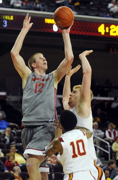 Washington State forward Brock Motum (12) shoots as Southern California guard Maurice Jones (10) and center James Blasczyk defend during the second half Saturday in Los Angeles. Washington State won 43-38. (Associated Press)