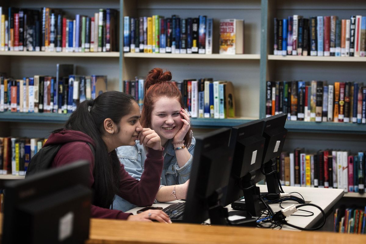 Lake City High School juniors Manmeet Kaur, left and Madison Carpenter spend time in the library after school in Coeur d