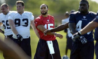 
Seneca Wallace, center, stretches with teammates before practice on Friday.
 (Christopher Anderson/ / The Spokesman-Review)