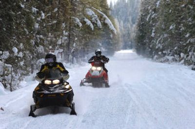 
Snowmobilers Kathy, left, and John Bymers, of Spokane, leave the Nordman area Dec. 9 en route to the popular trail system north of Priest Lake. 
 (Jesse Tinsley / The Spokesman-Review)