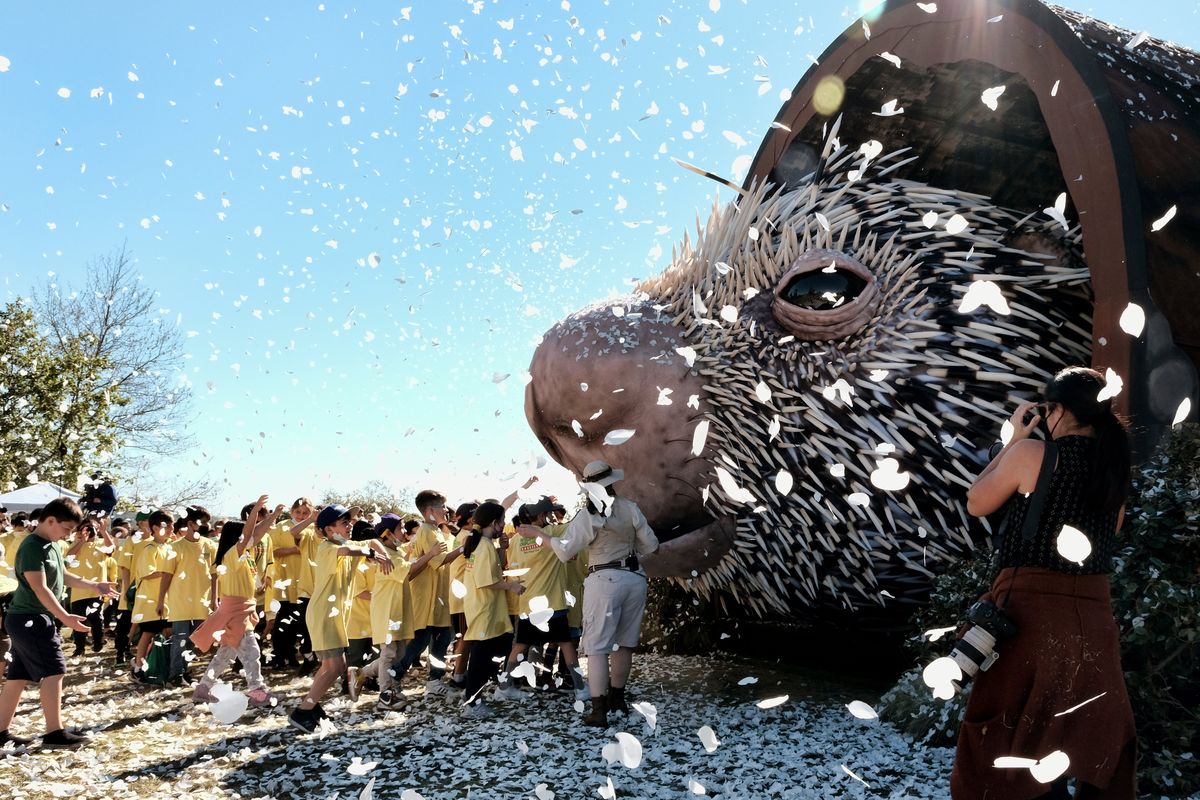 Los Angeles school children run to see a giant puppet porcupine named Percy on Tuesday at Elysian Park in Los Angeles.  (Richard Vogel)