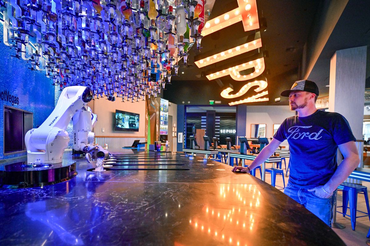 Lane Griffin of Colorado waits for his drink order at Tipsy Robot inside the Miracle Mile Shops at Planet Hollywood in Las Vegas on March 21. After a customers places their order at a self-serve kiosk, a robotic arm makes the cocktail.  (Washington Post)