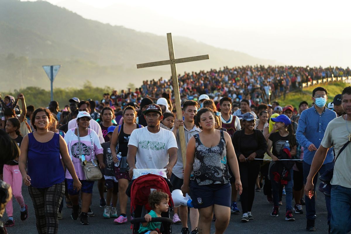 FILE - Migrants leave Huixtla, Chiapas state, Mexico, Oct. 27, 2021, as they continue their trek north toward Mexico's northern states and the U.S. border. The Biden administration struck agreement with Mexico to reinstate a Trump-era border policy next week that forces asylum-seekers to wait in Mexico for hearings in U.S. immigration court, U.S. officials said Thursday.  (Marco Ugarte)
