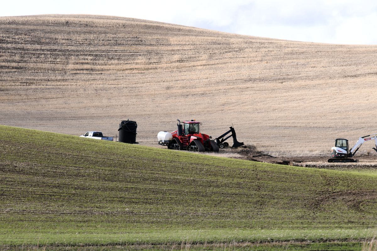 Crews continue work on Friday at the site of the Williams Pipeline rupture along Highway 195 about 5 miles northwest of Pullman.  (James Hanlon/The Spokesman-Review)