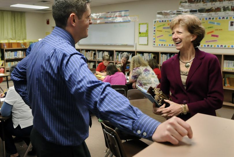 After seven years as superintendent of the West Valley School District, Polly Crowley is stepping down. She visits with Orchard Center Elementary School Principal Travis Peterson on Tuesday in Spokane Valley. (Dan Pelle)