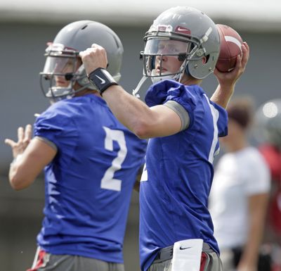 Washington State quarterbacks Connor Halliday, right, and Austin Apodaca, left, have both taken snaps with the first-team offense. (Associated Press)