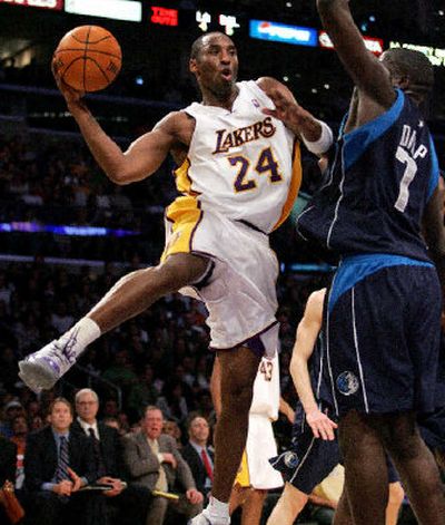 
Los Angeles Lakers' Kobe Bryant passes around Dallas Mavericks' DeSagana Diop in the first half.
 (Associated Press / The Spokesman-Review)