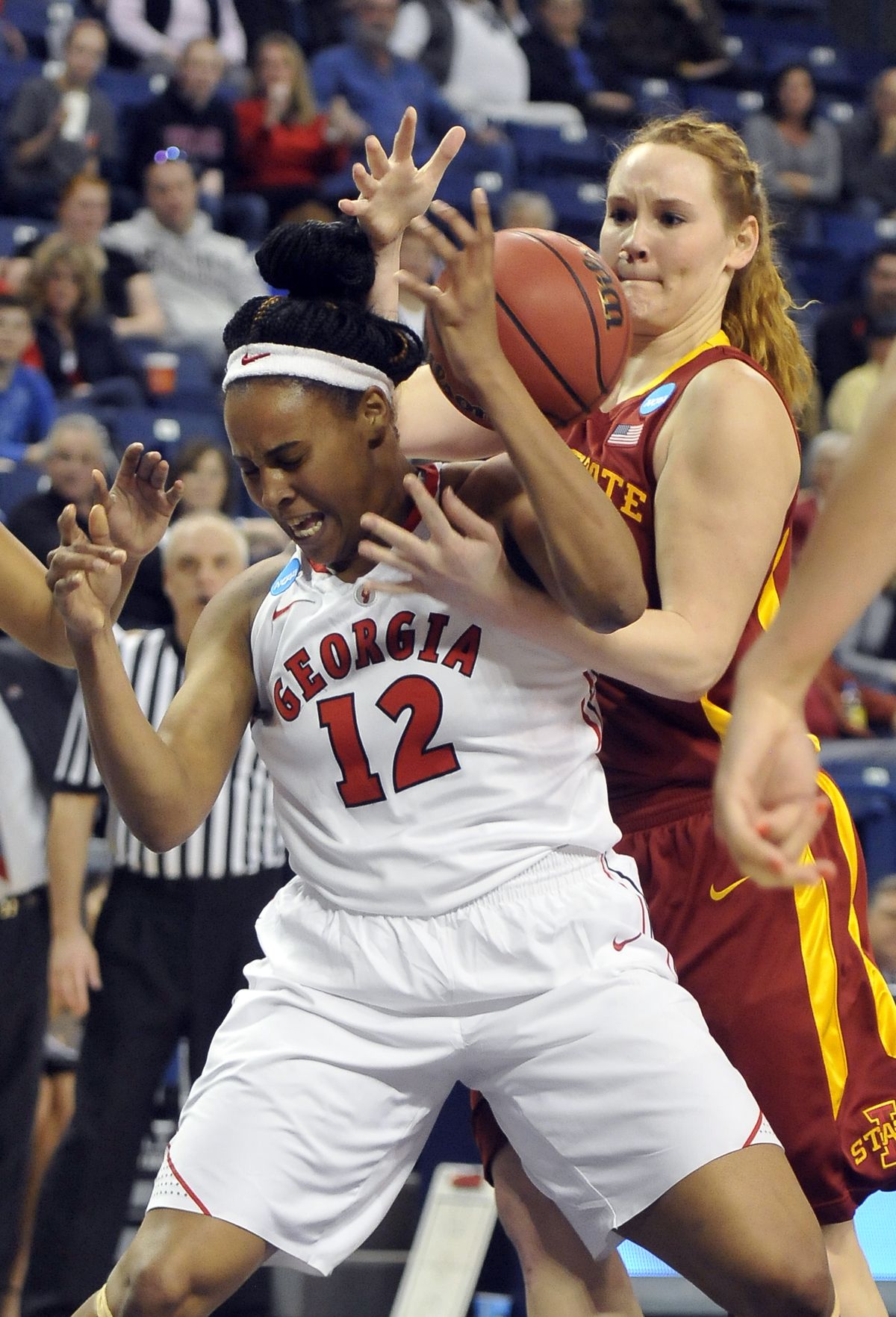Georgia’s Jasmine Hassell and Iowa State’s Chelsea Poppens try to corral a loose ball under the basket during the first half Monday at the McCarthey Athletic Center. (Jesse Tinsley)