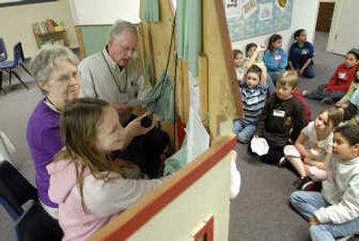 
Broadway Elementary School fourth-grader Katelyn Finney participates in a puppet show about following rules with Homework Club volunteers Keith and Janice Townsend.
 (Photos by J. BART RAYNIAK / The Spokesman-Review)