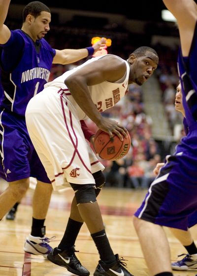 DeAngelo Casto, center, controls a rebound against Northwestern forward Drew Crawford, left. (Associated Press)