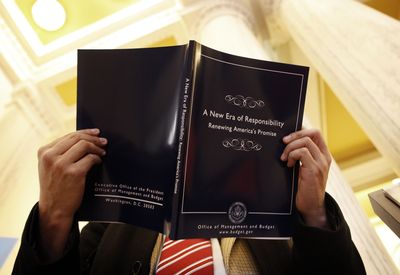 Humberto Sanchez reads over a copy of President Obama’s budget  at the U.S. Government Printing Office  on Thursday. (Associated Press / The Spokesman-Review)