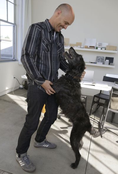 Martin Sprouse spends time with Grady, an Airedale terrier-Irish wolfhound mix, Thursday in Oakland, Calif. (Associated Press)