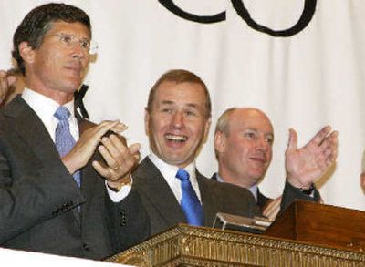 
 Phillip Bennett, center, then Chief Executive Officer of Refco, rings the opening bell at the New York Stock Exchange last month. 
 (Associated Press / The Spokesman-Review)