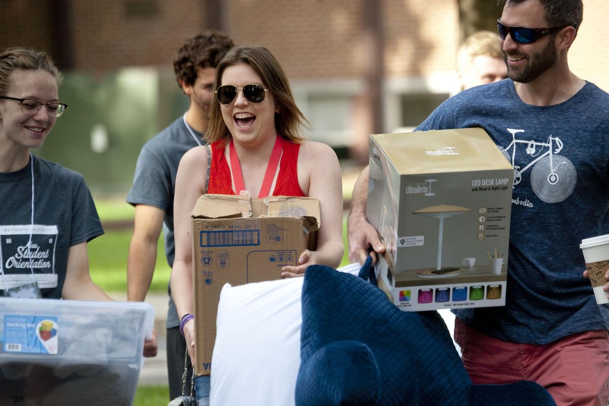 Whitworth University freshman Kaitlin Ray, of Seattle gets a little help from her dad Todd Ray during move in day at the college in Spokane on Saturday, Aug.31, 2019. (Kathy Plonka / The Spokesman-Review)