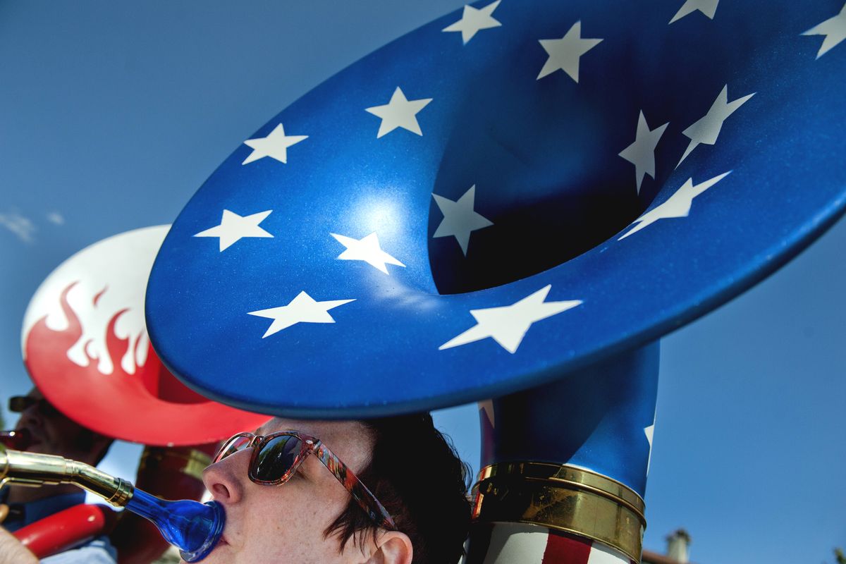 Sarah Windisch, a band teacher at Ponderosa Elementary, plays a decorated tuba in the local marching band, the Perfection-Nots, during the Fourth of July Parade in Coeur d’Alene on Wednesday. (TYLER TJOMSLAND photos)
