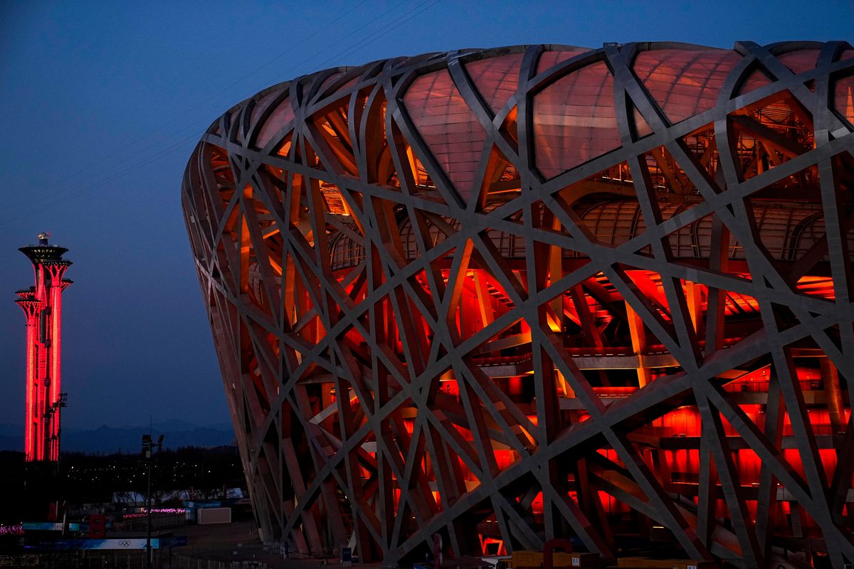 FILE - The National Stadium and the Beijing Olympic Tower are lit in red on the eve of the Chinese New Year ahead of the 2022 Winter Olympics, Jan. 31, 2022, in Beijing.  (Jae C. Hong)