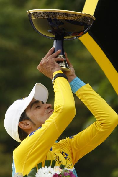 Alberto Contador raises the trophy on the podium after winning the Tour de France. (Associated Press)