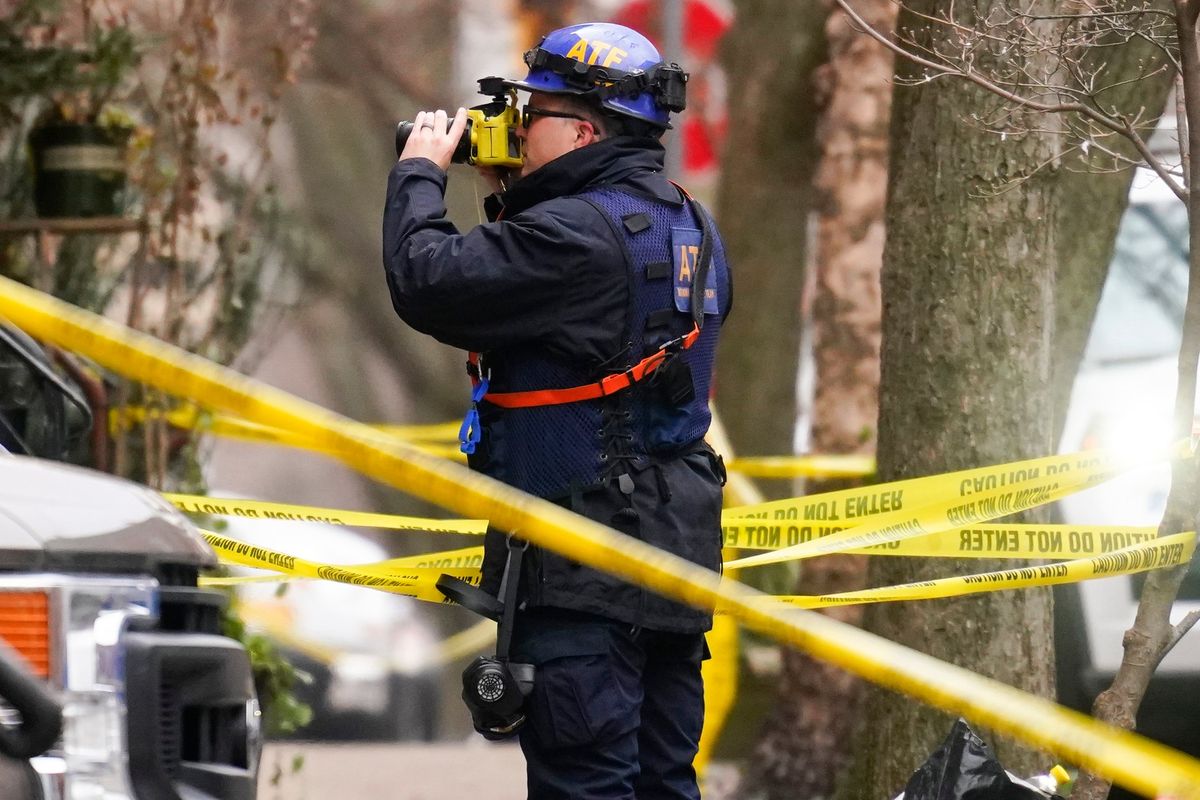 Investigators photograph the scene of Wednesday's fatal fire in the Fairmount neighborhood of Philadelphia, Thursday, Jan. 6, 2022. Officials say it's the city's deadliest single fire in at least a century.  (Matt Rourke)