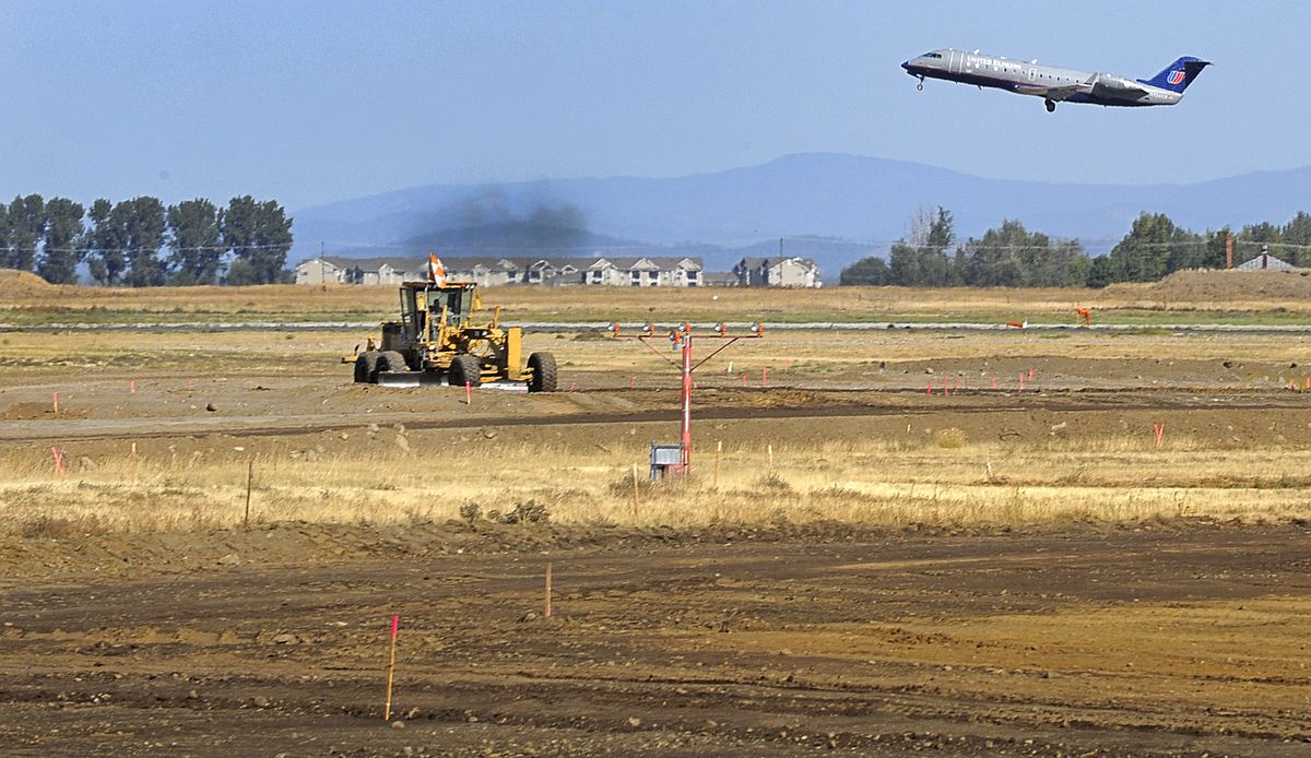 A grader works on a construction project at Spokane International Airport. (The Spokesman-Review)