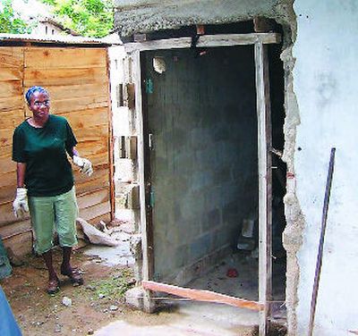 
Dermatologist Peggy Fuller paints and plasters houses that tsunami relief volunteers were building in Dalle, Sri Lanka, in 2005. Fuller took a sabbatical from her successful practice after seeing the magnitude of the tsunami devastation to spend several weeks making and hauling cinder blocks, carting dirt, carrying water and sweeping. 
 (Associated Press photos / The Spokesman-Review)