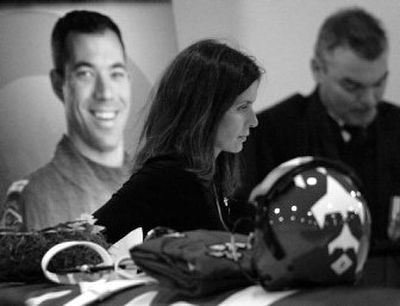 
Claudia Gaudreault, fiancée of Snowbirds pilot Shawn McCaughey, walks past his casket and photo during a funeral service Friday. 
 (Associated Press / The Spokesman-Review)