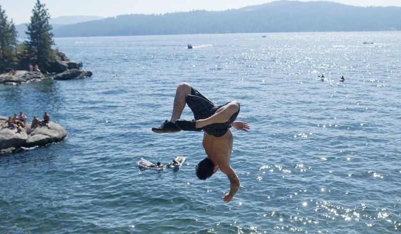 In this file photo, Brad Harrison of Spokane flings himself off the rocks of Tubbs Hill into beautiful Lake Coeur d'Alene. A New York website considers Lake Coeur d’Alene to be the “best damn thing” about Idaho. (Jesse Tinsley/THE SPOKESMAN-REVIEW file photo)