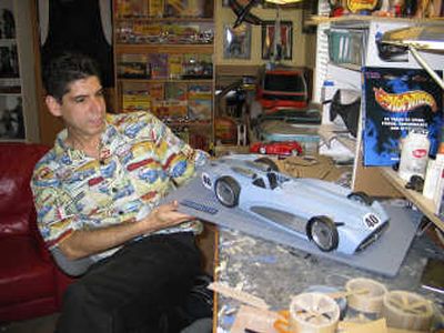 
Auto designer Amaury Diaz Serrano is shown with a model of the 