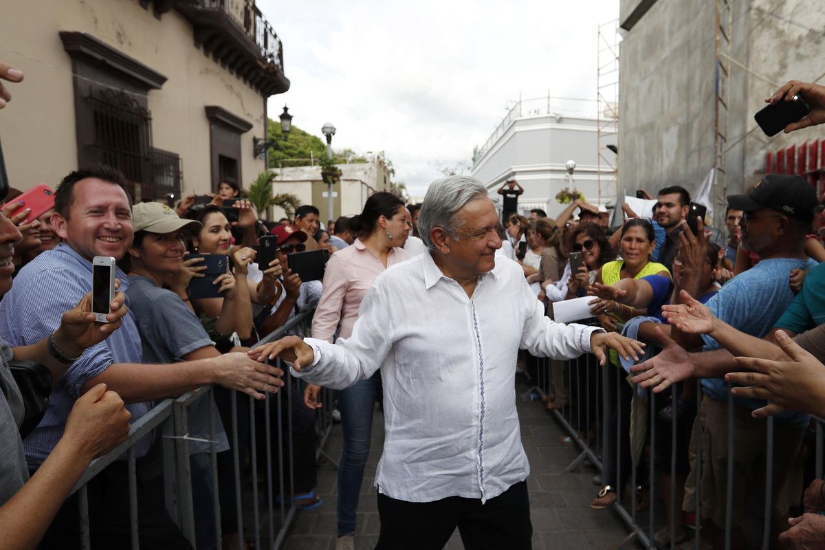 Mexico’s President-elect Andres Manuel Lopez Obrador greets supporters Sept. 16, 2018, as he kicks off a nationwide tour after his election in Mazatlan, Mexico. Lopez Obrador is folksy, plain-spoken, and spontaneous, perhaps too much so for financial markets, which have been roiled in advance of his inauguration on Saturday. (Eduardo Verdugo / AP)