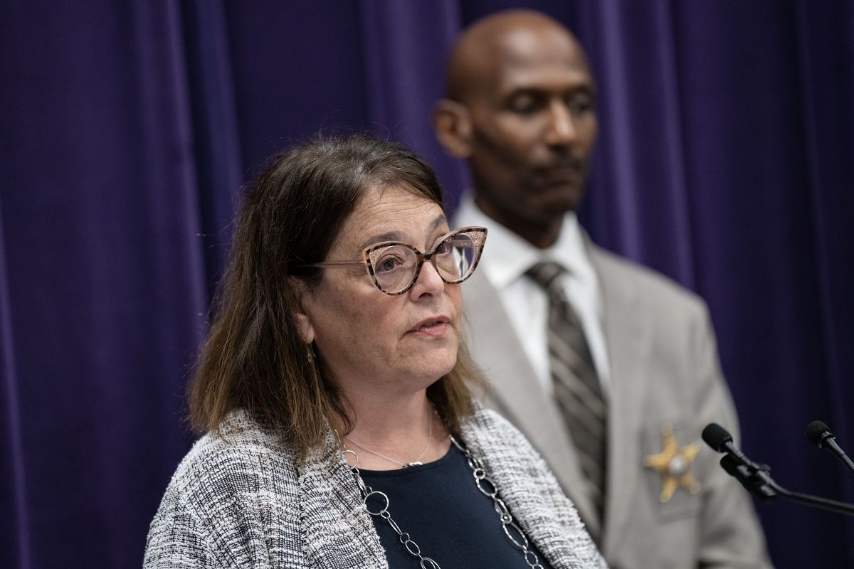 Aileen Robinson, Chicago police director of crime victim services, describes the response to a weekend mass shooting in the North Lawndale neighborhood at police headquarters, July 31 as Interim police Superintendent Fred Waller looks on.    (Tribune News Service)