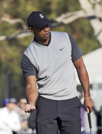 Tiger Woods tries to coax a putt on the 14th green during the first round of the Genesis Open golf tournament at Riviera Country Club in the Pacific Palisades neighborhood of Los Angeles on Thursday, Feb. 15, 2018. (Reed Saxon / Associated Press)