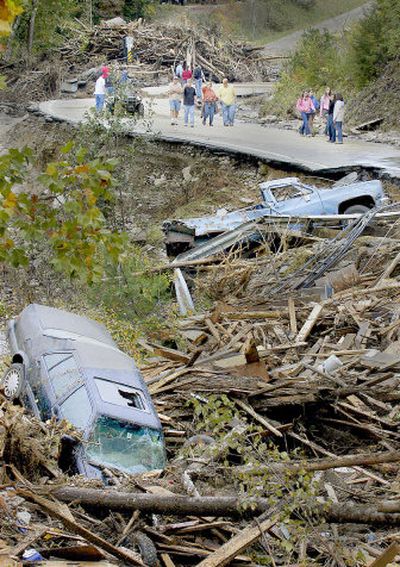 
Residents of Alstead, N.H., survey the damage to Route 123A, where flooding from the Cold River washed away huge sections of road on Sunday. 
 (Associated Press / The Spokesman-Review)