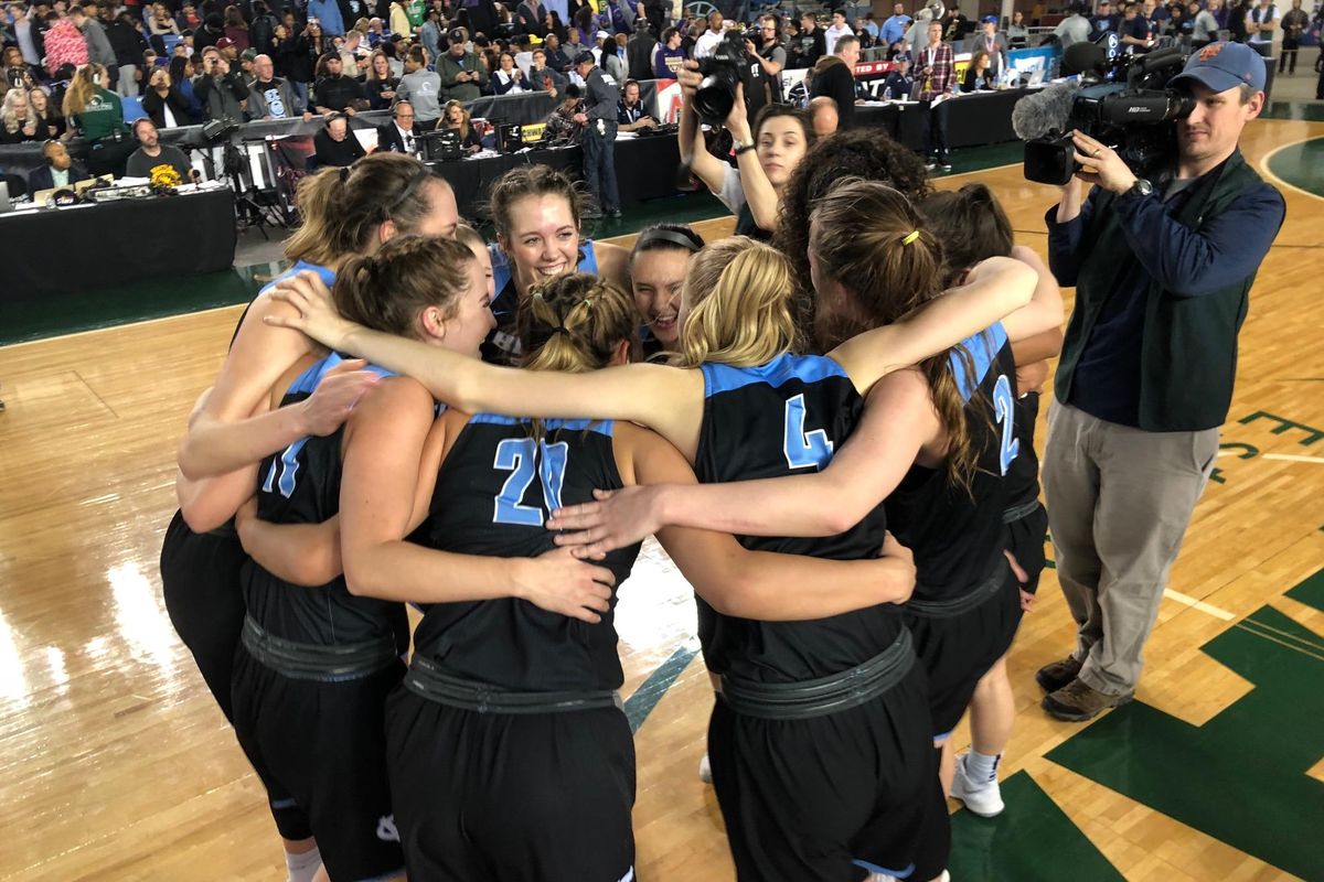 Members of the Central Valley girls team celebrate their 70-39 win over Woodinville in the state 4A championship game at the Tacoma Dome on Saturday, March 3, 2018. (Dave Nichols / The Spokesman-Review)