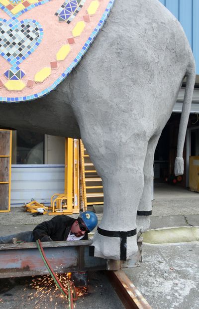 Bob Richards of Shoreline Sign & Awning uses a welding torch for some last-minute work on the Aurora Rents Elephant in Seattle last Monday.  (Associated Press / The Spokesman-Review)