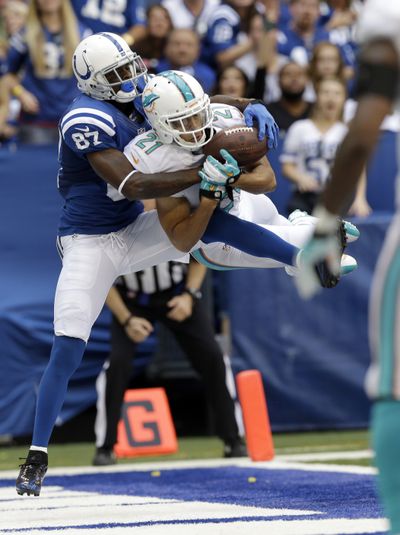 The Dolphins’ Brent Grimes intercepts a pass in the end zone intended for the Colts’ Reggie Wayne. (Associated Press)
