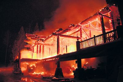 Flames outline the timbers of the Idaho Club’s iconic clubhouse, which was destroyed by fire on Thursday. No one was in the building at the time of the fire, which broke out shortly before 4 p.m. (Associated Press / The Spokesman-Review)