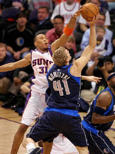 
Shawn Marion of the Phoenix Suns blocks a first-quarter shot by Dallas' Dirk Nowitzki. 
 (Associated Press / The Spokesman-Review)