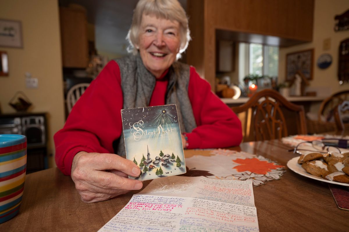 Cassie Hill of Deer Park holds the Christmas card she and a friend have been sending back and forth to each other as a gag for 65 years on Wednesday, Nov. 10, 2022. They wrote several messages inside the card, then added a piece of paper with dozens more messages about the yearly happenings in their lives.  (Jesse Tinsley/THE SPOKESMAN-REVI)