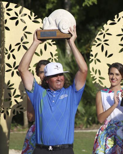 Pat Perez of the United States holds up his trophy after he won the OHL Classic at Mayakoba golf tournament in Playa del Carmen, Mexico. (Israel Leal / Associated Press)