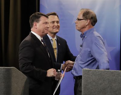 Senate candidates from left, Todd Rokita, Luke Messer and Mike Braun speak with each other following the Indiana Republican senate primary debate April 30, 2018 in Indianapolis. (Darron Cummings / Associated Press)