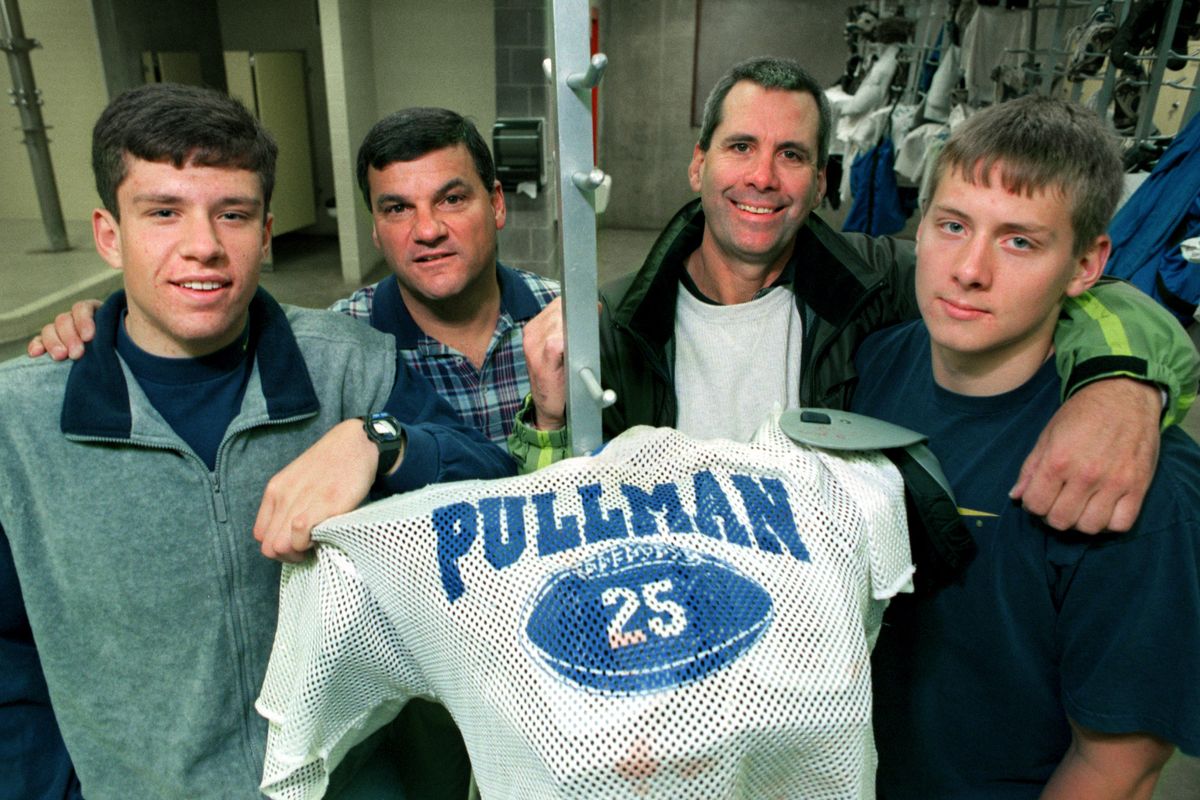 While coaching at Washington State, Craig Bray, second from right, poses with his son Trent, right, and fellow coach Jim Zeches and his son Brian, while the two played high school football at Pullman.  (The Spokesman-Review Photo Archive)