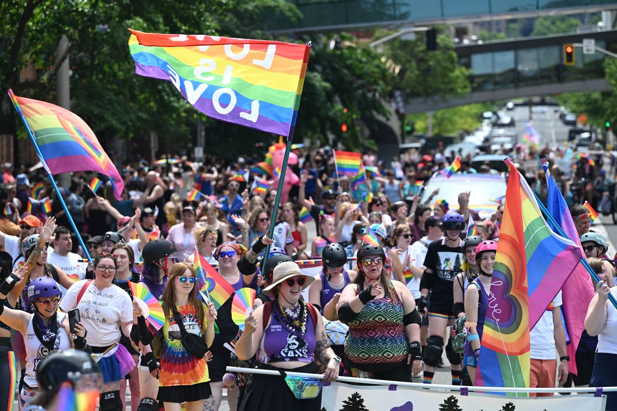 Parade participants walk down Howard Street toward Riverfront Park on Saturday in the annual Spokane Pride Parade.  (Jesse Tinsley/THE SPOKESMAN-REVIEW)