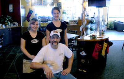 
Rick Demmig, front, the owner of Moon Dollars coffee house in Post Falls, poses with his staff, including Jessica Jordan, left and Andrea Bourget. 
 (Kathy Plonka / The Spokesman-Review)