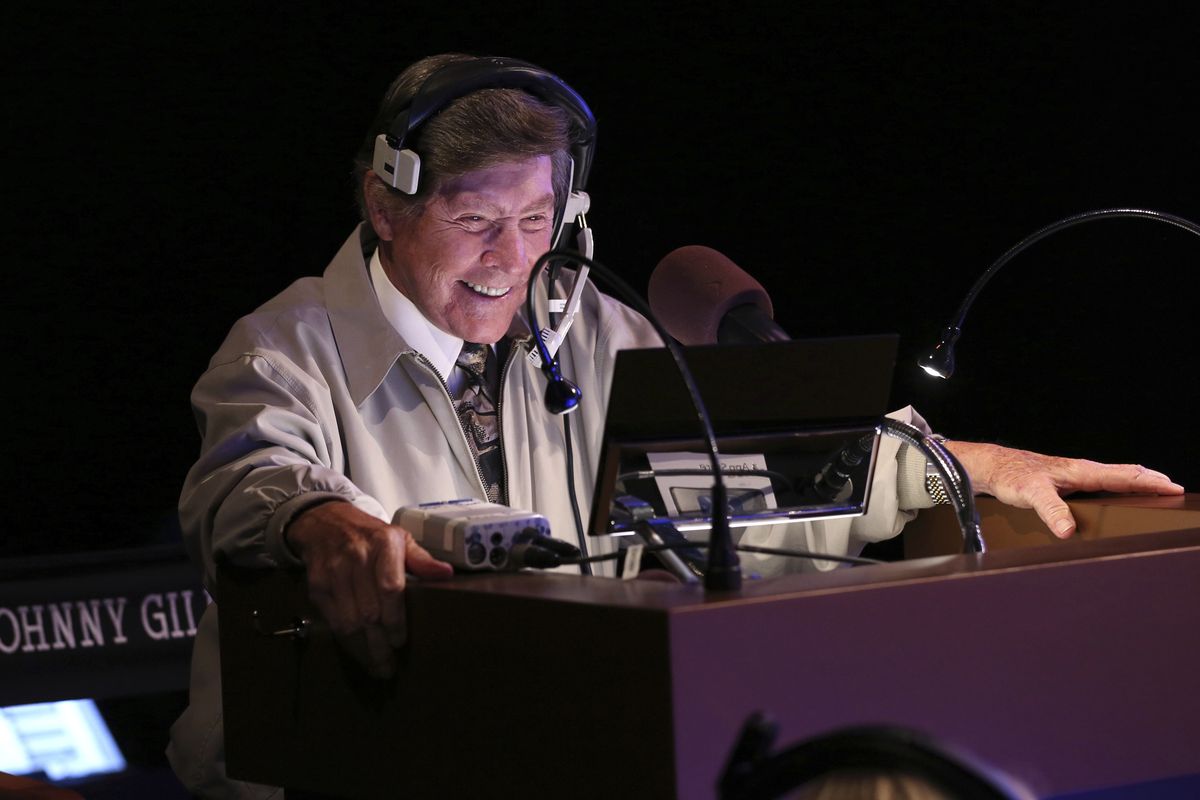 In this image provided by Jeopardy Productions, Inc., show announcer Johnny Gilbert appears on the set of "Jeopardy!" Gilbert worked with host Alex Trebek for 37 years and was reluctant to continue after losing his admired colleague. But others with the show urged him to consider his role as a comforting touchstone for viewers who also were in mourning.  (Carol Kaelson)