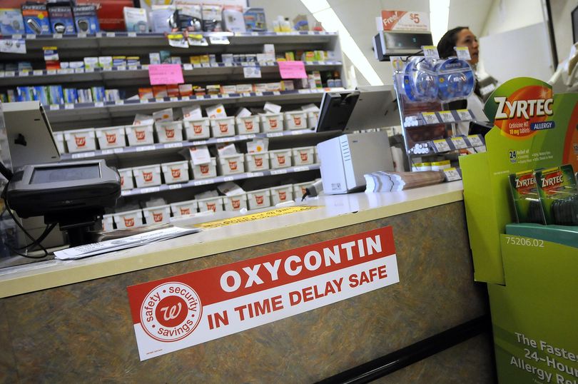Signs announce the installation of time-delay safes at the Walgreens store  at Division Street and Empire Avenue in Spokane. (CHRISTOPHER ANDERSON / The Spokesman-Review)