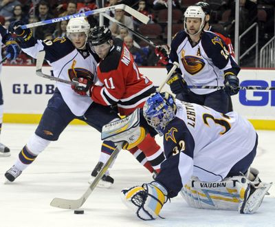 Atlanta Thrashers goaltender Kari Lehtonen covers the puck on his way to a shutout of the Devils at New Jersey.  (Associated Press / The Spokesman-Review)