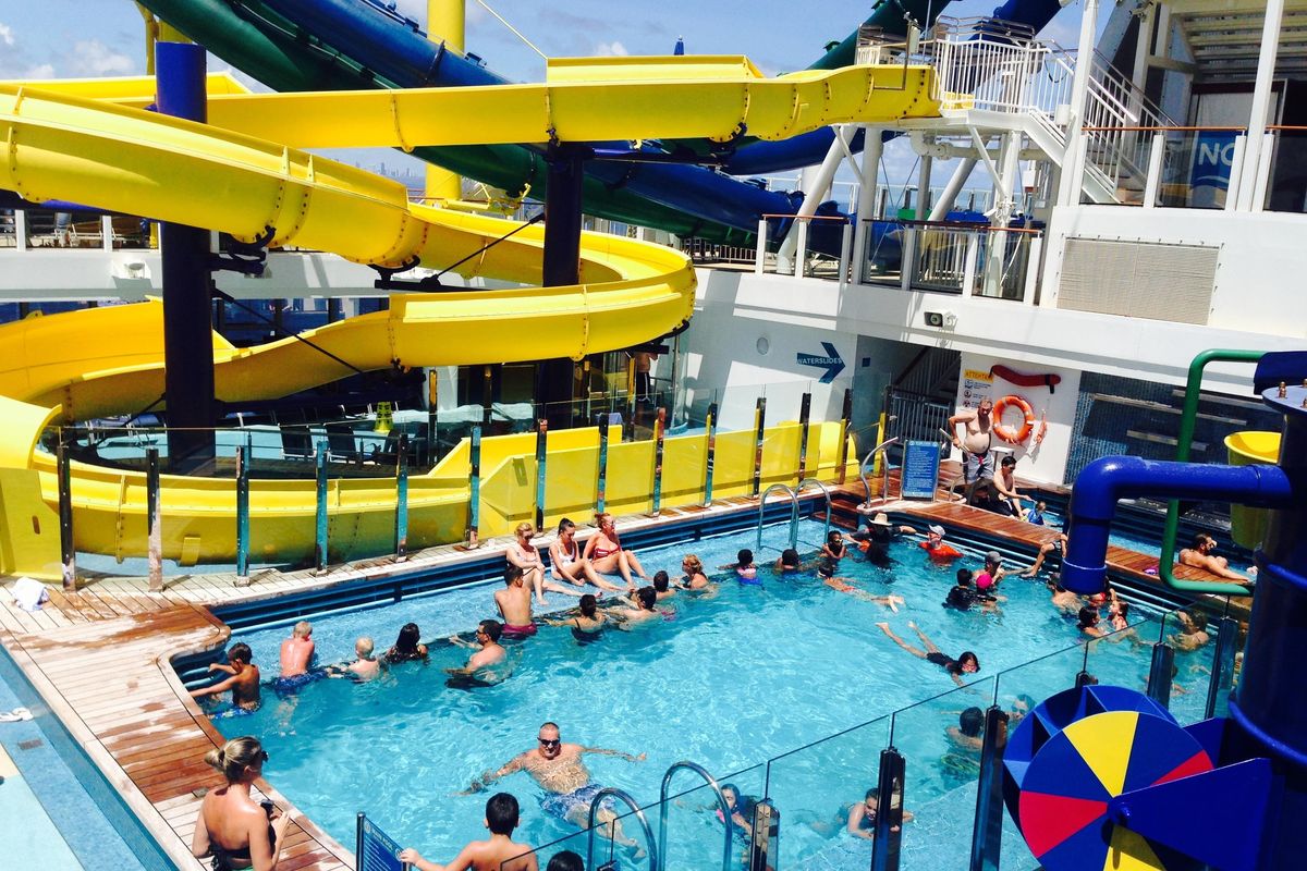 In this Thursday, Sept. 7, 2017 photo, passengers aboard the Norwegian Escape cruise ship relax in a pool just hours before the huge vessel returned to Miami, two days earlier than scheduled due to powerful Hurricane Irma. (Brian Witte / Associated Press)