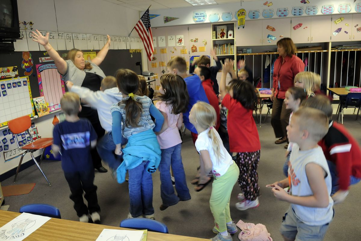“Who is wearing green today, green today, green today? Who is wearing green today? Jump up high!” instructs Trentwood Elementary kindergarten teacher Shaunda Paske, to the  extended day class. (J. BART RAYNIAK / The Spokesman-Review)