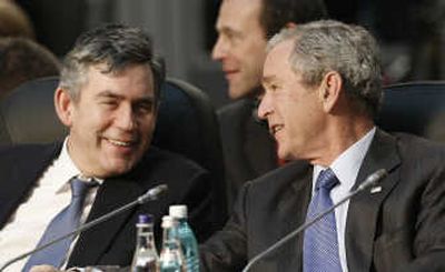 
President  Bush talks with British Prime Minister Gordon Brown  at the NATO summit in Romania on  Thursday. Associated Press
 (Associated Press / The Spokesman-Review)