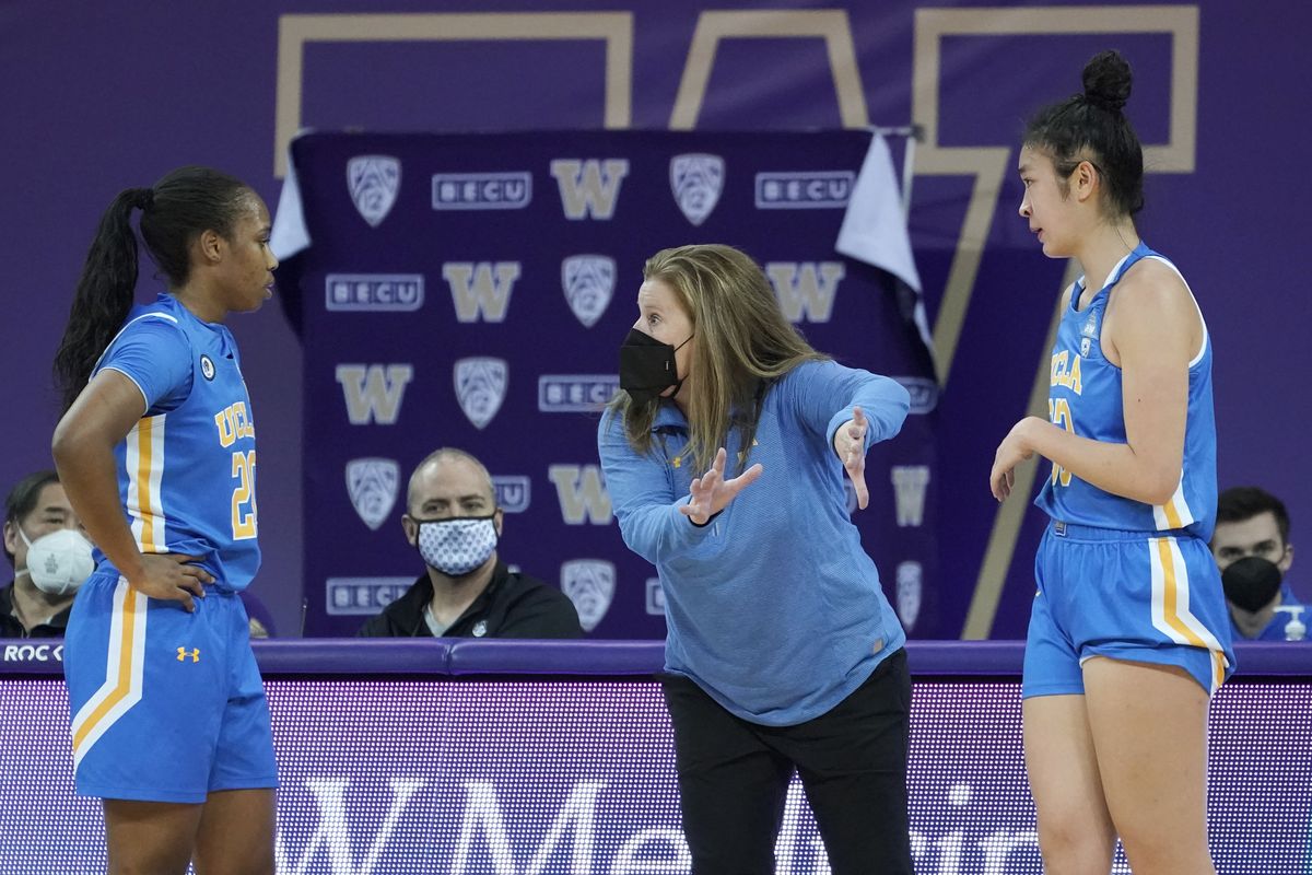 UCLA head coach Cori Close, center, talks with guard Charisma Osborne, left, and guard Natalie Chou, right, during the second half of an NCAA college basketball game against Washington, Sunday, Feb. 7, 2021, in Seattle.  (Ted S. Warren)